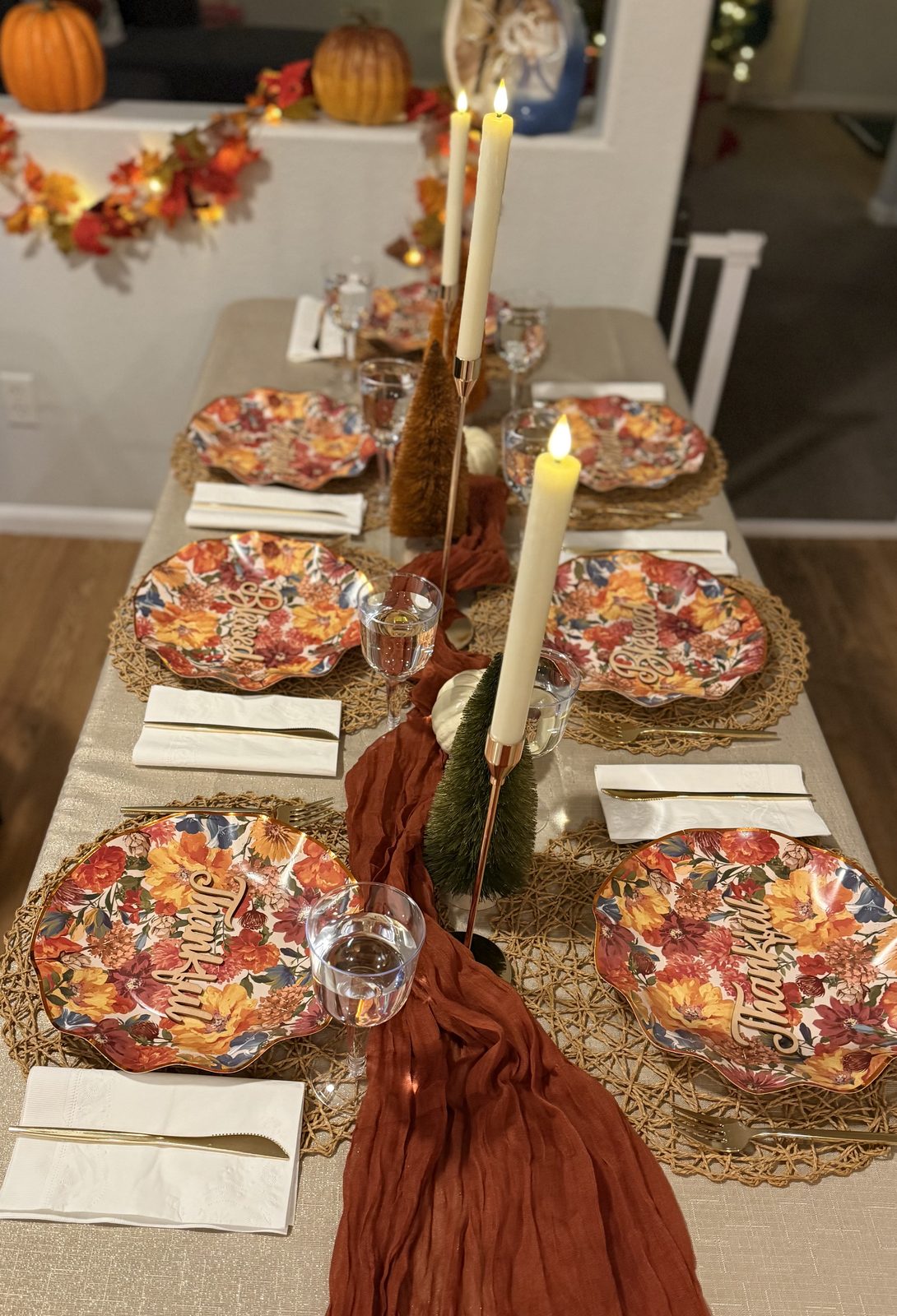 Thanksgiving tablescape with rust napkins and candles
